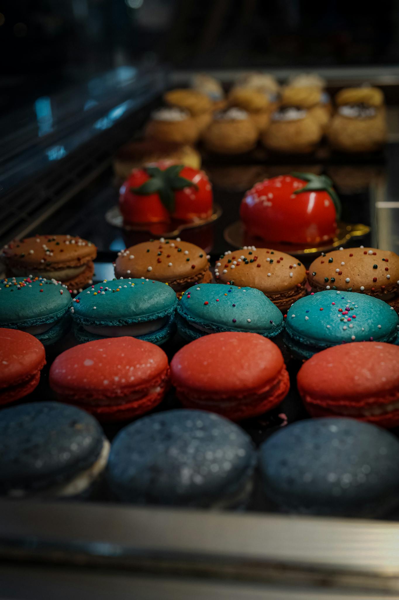 A close-up of vibrant macarons and intricate pastries in a bakery.