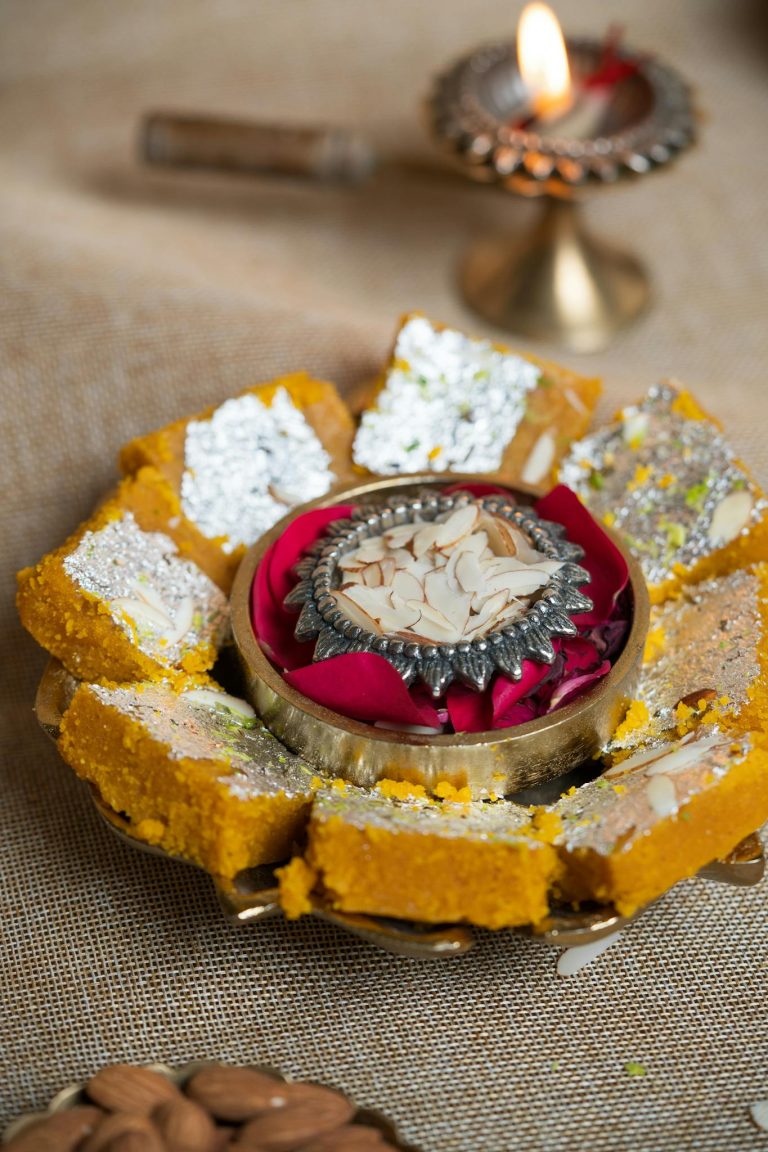 Close-up of homemade Indian sweets on a decorative plate, perfect for festive occasions.